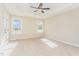 Spacious main bedroom featuring tray ceilings, carpet flooring, recessed lighting, and two windows at 68 Tee Dr, Selma, NC 27576