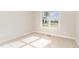 Bedroom featuring a window with a view and neutral carpet and walls. The room has ample natural light at 68 Tee Dr, Selma, NC 27576