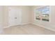 Bedroom features a neutral carpet, white walls, window with a view, and closet with double doors at 68 Tee Dr, Selma, NC 27576
