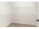 Walk-in closet features neutral carpeting, white walls, base trim, and multiple rows of wire shelving at 68 Tee Dr, Selma, NC 27576