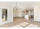 Open-concept dining room featuring hardwood floors, natural light and is open to the living room and kitchen at 68 Tee Dr, Selma, NC 27576