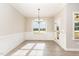 Elegant dining room featuring wainscoting, hardwood floors, and a stylish chandelier, great for entertaining at 68 Tee Dr, Selma, NC 27576