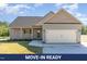 Charming single-story home with a two-car garage, well-manicured lawn, and inviting curb appeal at 68 Tee Dr, Selma, NC 27576