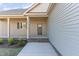 Inviting front porch with classic columns, brick accents, and a well-maintained lawn, offering curb appeal at 68 Tee Dr, Selma, NC 27576