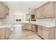 Bright kitchen features an island, stone counters, tile backsplash, and opens to the living and dining area at 68 Tee Dr, Selma, NC 27576