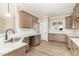 Modern kitchen with shaker cabinets, granite countertops, stainless steel sink, and backsplash at 68 Tee Dr, Selma, NC 27576