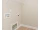 An empty laundry room with connections ready for a washer and dryer at 68 Tee Dr, Selma, NC 27576