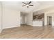Open-concept living room with hardwood floors, a vaulted ceiling with fan, and open to the kitchen at 68 Tee Dr, Selma, NC 27576