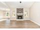 Spacious living room with hardwood floors, a cozy fireplace, and large windows for abundant natural light at 68 Tee Dr, Selma, NC 27576