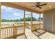 Back porch features a ceiling fan with a view of a large grassy yard at 68 Tee Dr, Selma, NC 27576