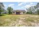 Back view of a house and yard with ample space and a screened-in porch, perfect for enjoying outdoor living at 702 Tuscany Cir, Princeton, NC 27569