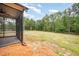 Expansive backyard view with a screened porch, offering a blend of indoor-outdoor living at 702 Tuscany Cir, Princeton, NC 27569