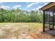 A large backyard with ample space and a screened porch area for outdoor enjoyment at 702 Tuscany Cir, Princeton, NC 27569