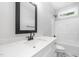 Modern bathroom featuring a quartz countertop, vanity, and shower-tub combination at 702 Tuscany Cir, Princeton, NC 27569