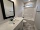 Bathroom featuring single sink vanity with granite counters and tub with shower at 702 Tuscany Cir, Princeton, NC 27569