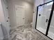 Bathroom featuring a glass shower with black trim and herringbone patterned floors at 702 Tuscany Cir, Princeton, NC 27569