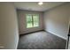 Cozy bedroom with neutral carpet, a window providing natural light, and ample space for relaxation at 702 Tuscany Cir, Princeton, NC 27569