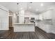Bright kitchen features an island with seating, pendant lighting, gray backsplash and stainless steel appliances at 702 Tuscany Cir, Princeton, NC 27569
