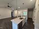 Stylish kitchen island with granite countertops, pendant lighting, and stainless steel appliances, perfect for entertaining at 702 Tuscany Cir, Princeton, NC 27569