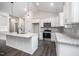 Bright kitchen features an island with seating, gray backsplash and stainless steel appliances at 702 Tuscany Cir, Princeton, NC 27569