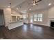 Kitchen and living room featuring granite counters, pendant lights, and an open concept at 702 Tuscany Cir, Princeton, NC 27569