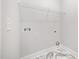 Laundry room with marble floors, white walls, hookups, light switch and wire rack at 702 Tuscany Cir, Princeton, NC 27569