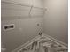 The laundry room offers a wire shelf with marble-style flooring, making it a practical and stylish space at 702 Tuscany Cir, Princeton, NC 27569