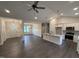 Bright, open-concept living space with a modern kitchen island and stainless appliances, seamlessly connecting to the dining area at 702 Tuscany Cir, Princeton, NC 27569