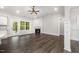 Sunlit living room featuring a fireplace, wood floors, and white accents with backyard access at 702 Tuscany Cir, Princeton, NC 27569