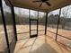 Enclosed patio featuring a ceiling fan, offering a relaxing outdoor space with a view of the yard at 702 Tuscany Cir, Princeton, NC 27569