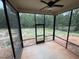 Spacious screened porch with ceiling fan; ideal for outdoor enjoyment and overlooking wooded backyard at 702 Tuscany Cir, Princeton, NC 27569