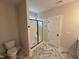 Modern bathroom featuring a glass-enclosed shower with black trim and stylish flooring at 702 Tuscany Cir, Princeton, NC 27569