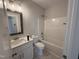 Bathroom featuring a single sink vanity, white cabinets and tub shower at 71 Royal Ave, Selma, NC 27576