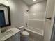Bathroom with single sink vanity, shower-tub combo and tile flooring at 71 Royal Ave, Selma, NC 27576
