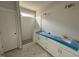 Bathroom featuring double sink vanity, white subway tile shower, and hexagon tile flooring at 71 Royal Ave, Selma, NC 27576