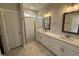 Bathroom with double sink vanity, tile flooring and subway tile shower with glass door at 71 Royal Ave, Selma, NC 27576