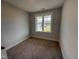Cozy bedroom with a window offering natural light and neutral carpeting at 71 Royal Ave, Selma, NC 27576