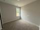 Bedroom with a window, neutral walls, and comfortable carpet flooring at 71 Royal Ave, Selma, NC 27576