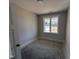 Bright bedroom with a large window, providing ample natural light and views of the neighborhood at 71 Royal Ave, Selma, NC 27576