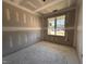 Unfinished room showcasing a large window, perfect for creating your ideal bedroom space at 71 Royal Ave, Selma, NC 27576