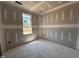 Bedroom with a large window for natural light, in need of flooring and paint to complete at 71 Royal Ave, Selma, NC 27576