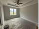Primary bedroom with a large window and tray ceiling at 71 Royal Ave, Selma, NC 27576