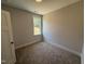 Neutral bedroom showcasing plush carpet, and a light-filled window at 71 Royal Ave, Selma, NC 27576