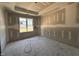 Unfinished bedroom showcasing a bright window and tray ceiling, perfect for creating your personalized retreat at 71 Royal Ave, Selma, NC 27576