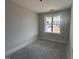 Empty bedroom with a large window and electrical outlets at 71 Royal Ave, Selma, NC 27576