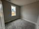 Bedroom features a window, neutral paint color, and base molding at 71 Royal Ave, Selma, NC 27576