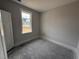 This bedroom has a door, a window that lets in natural light, and unfinished floors at 71 Royal Ave, Selma, NC 27576