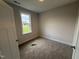 Bright bedroom features plush carpet, neutral walls, white trim and window view of the neighborhood at 71 Royal Ave, Selma, NC 27576