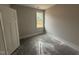 Bedroom features a window, neutral paint color, and base molding at 71 Royal Ave, Selma, NC 27576