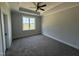 Spacious bedroom with tray ceiling, neutral paint, plush carpet and a view of the neighborhood at 71 Royal Ave, Selma, NC 27576